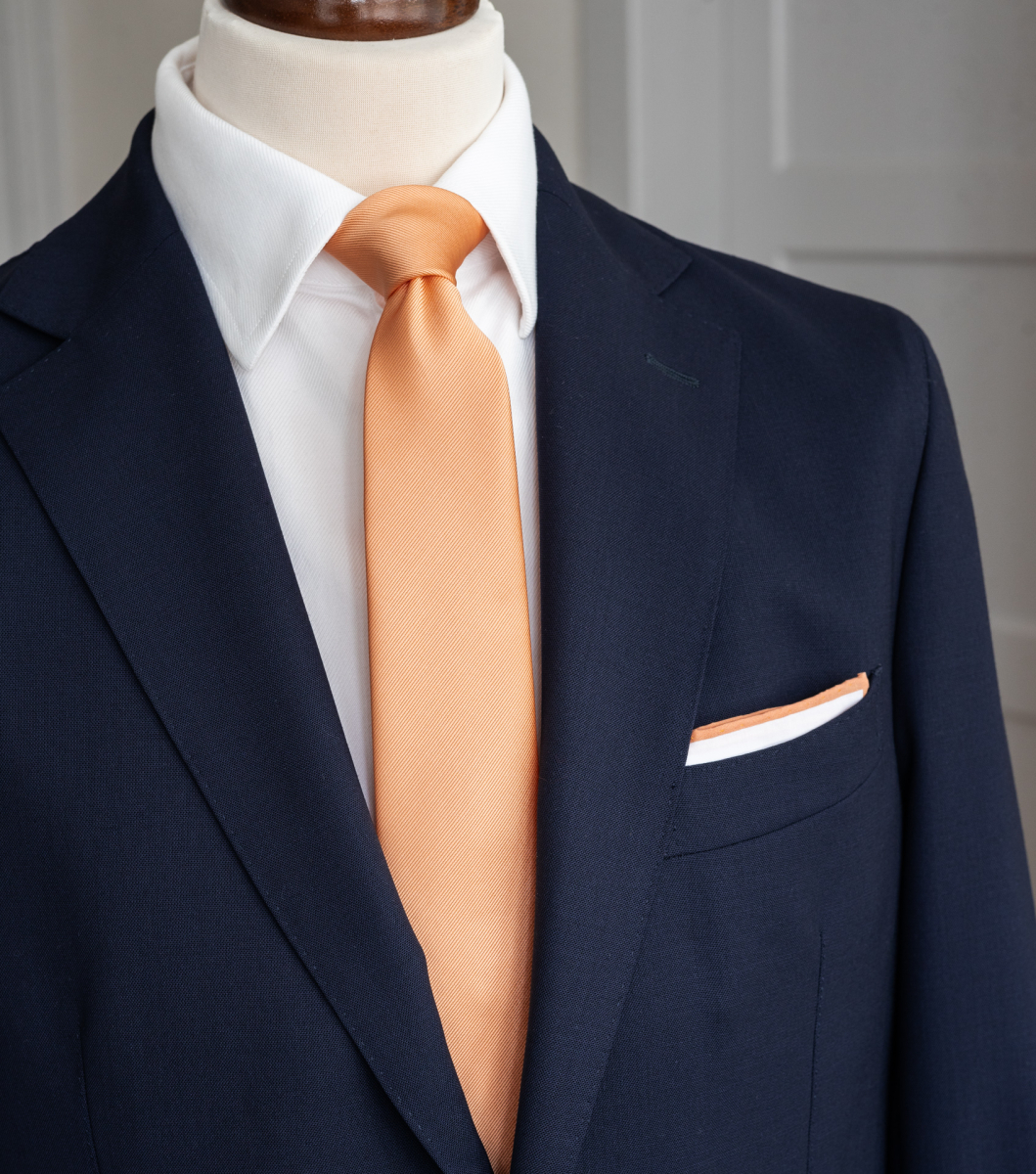 navy blue suit peach tie